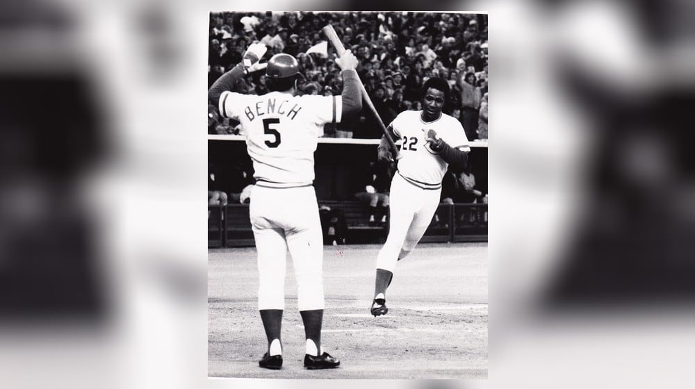 Cincinnati Reds catcher Johnny Bench is there to greet teammate Dan Driessen after he scores a run during the 1976 World Series. DDN FILE